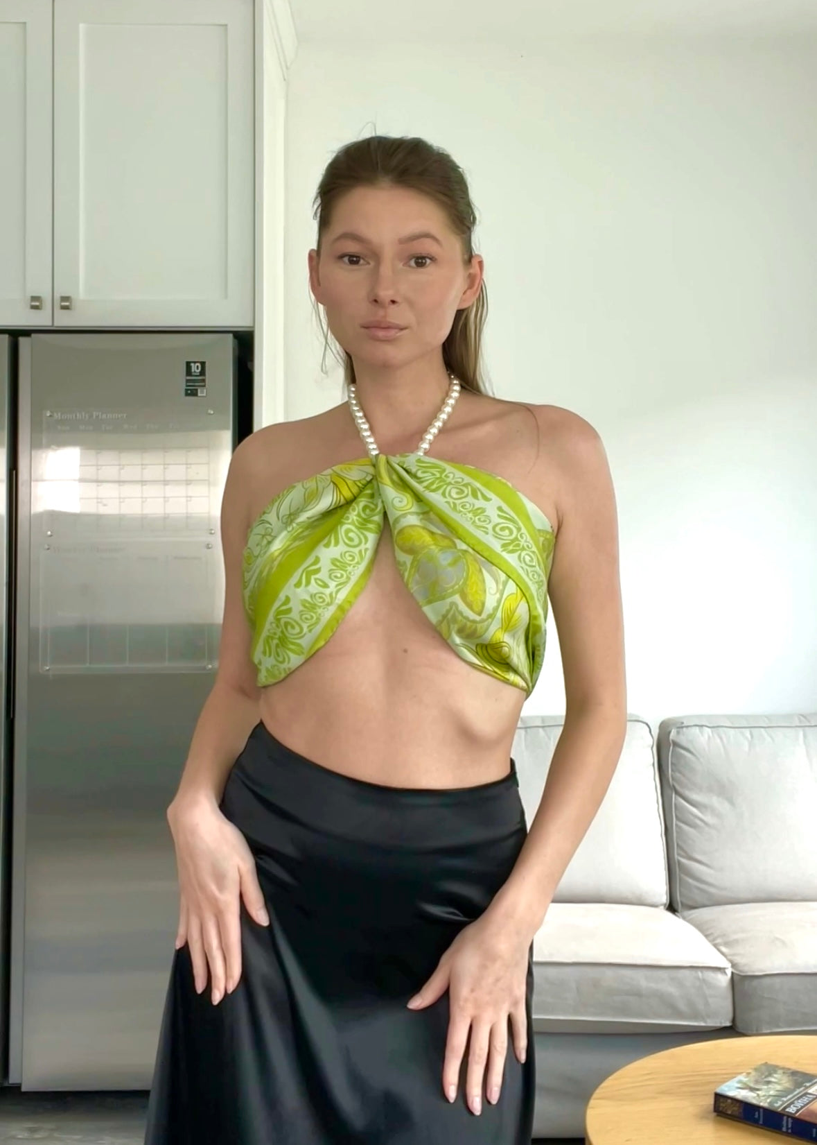 Video of a woman styling the Dorabella green and beige silk scarf in multiple elegant ways — versatile summer looks with a luxury Italian silk scarf.