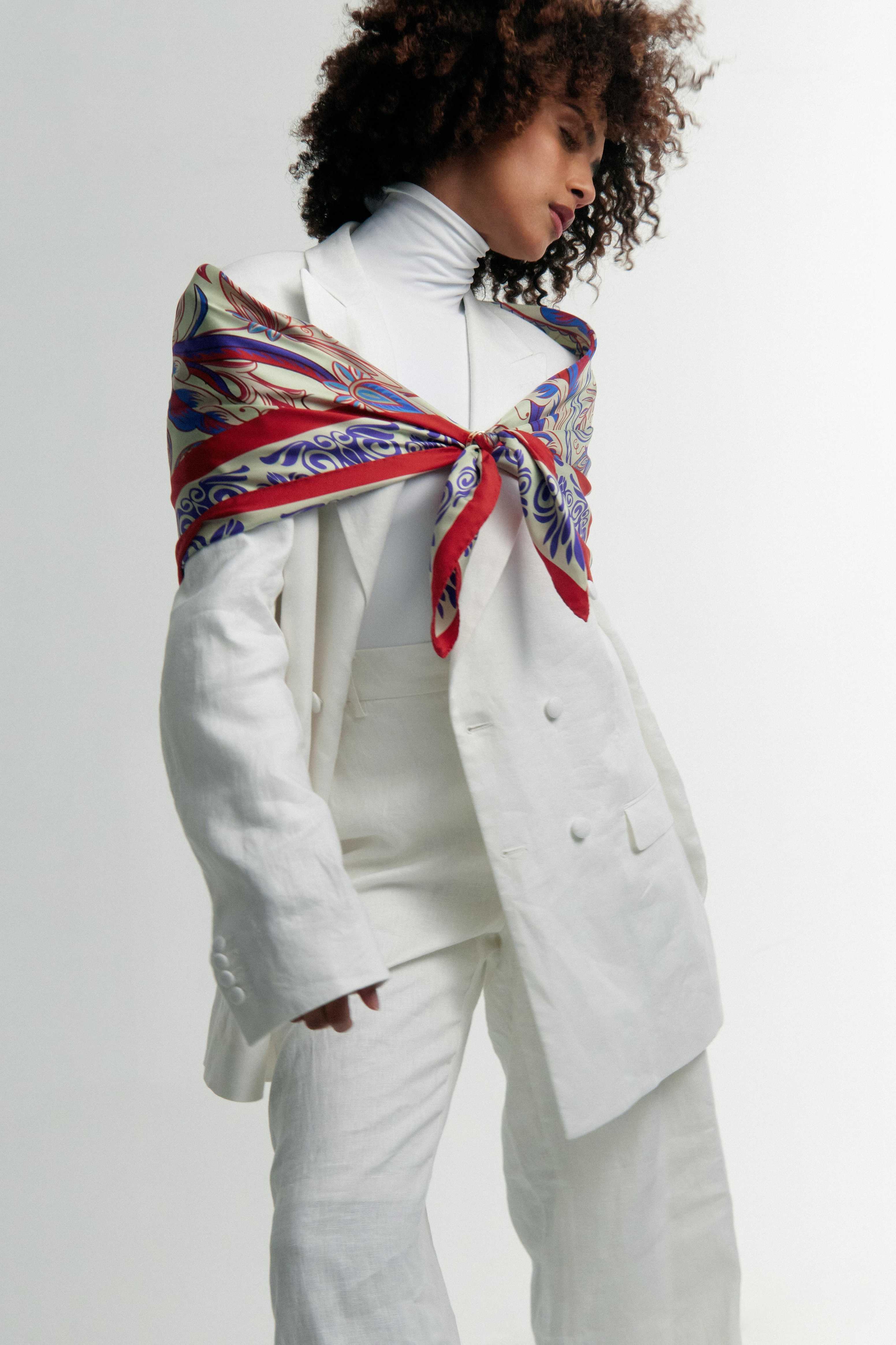 Model wearing the Rubino Petite red and blue silk scarf wrapped around her — bold and elegant styling with Italian silk twill.