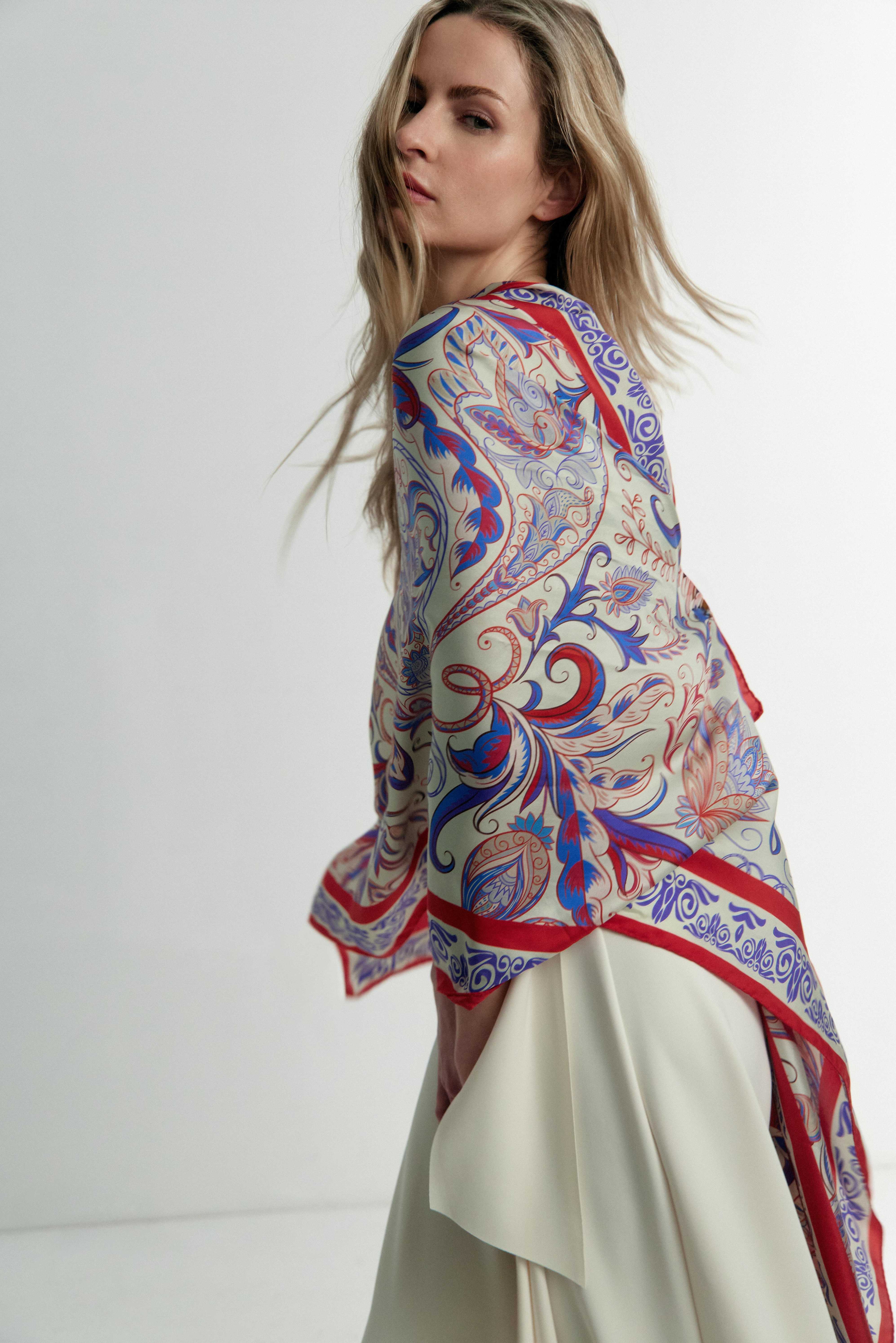 Model wearing the Rubino red and blue silk scarf wrapped around her — chic and elegant styling with Italian silk twill.